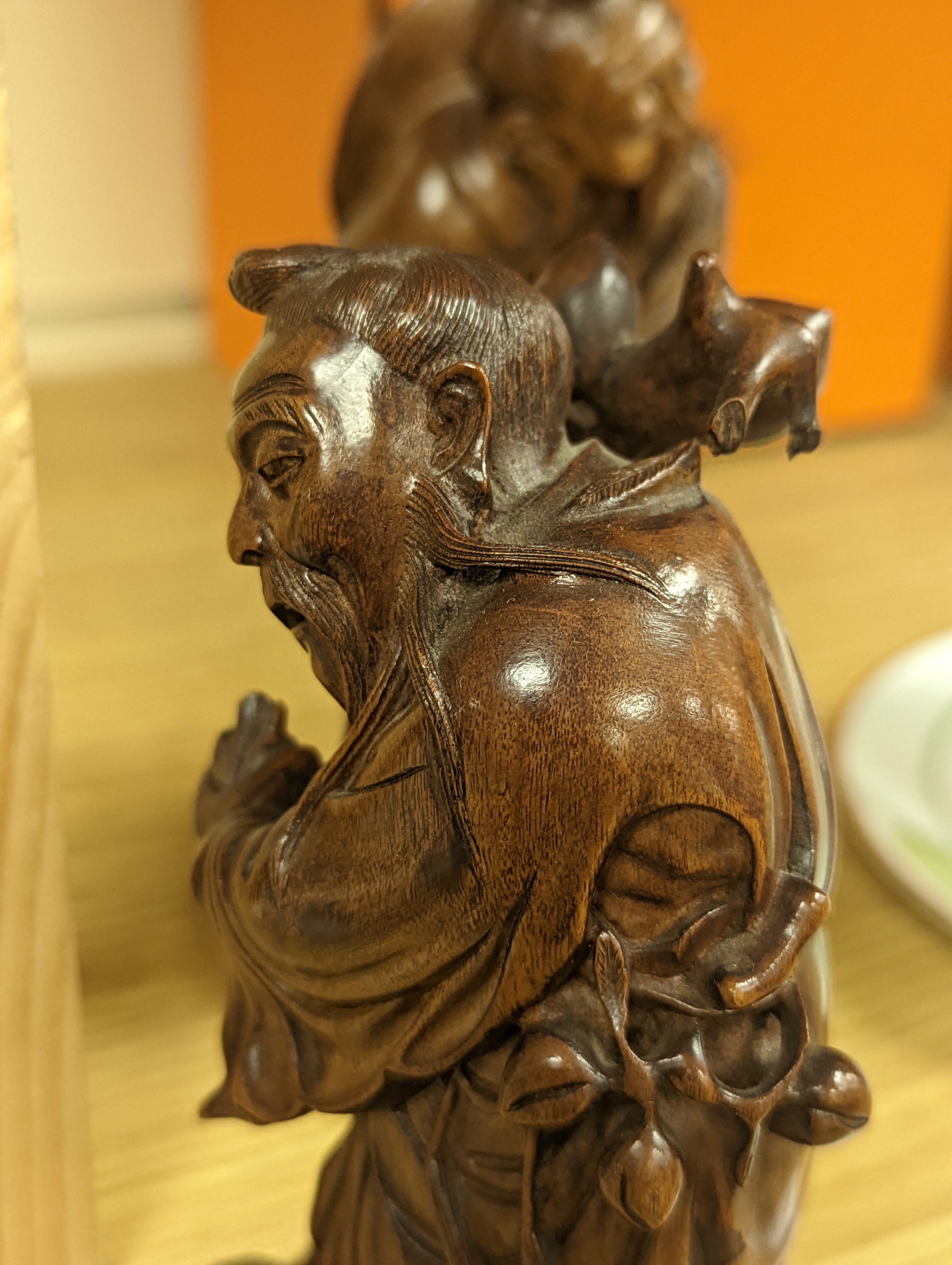 Two Chinese hardwood figures of a fisherman and a old man holding peaches 16cm